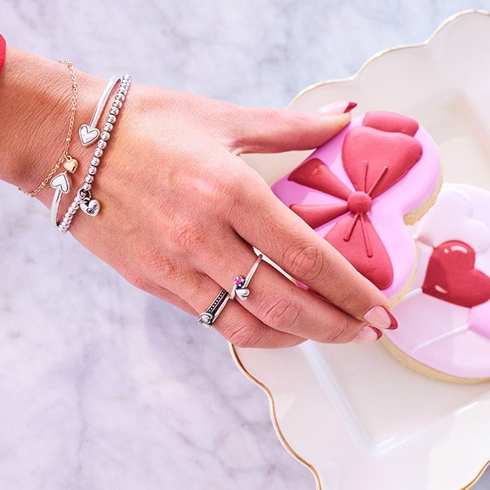 Sterling Silver bracets and rings on hand reaching for cookie