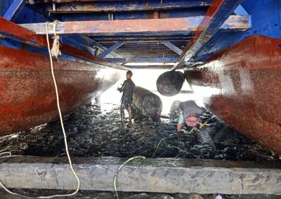 The SEA People Boat Drydock In the Mud Cleaning and Repairing Hulls 2 Reef Restoration Coral Gardeners Raja Ampat