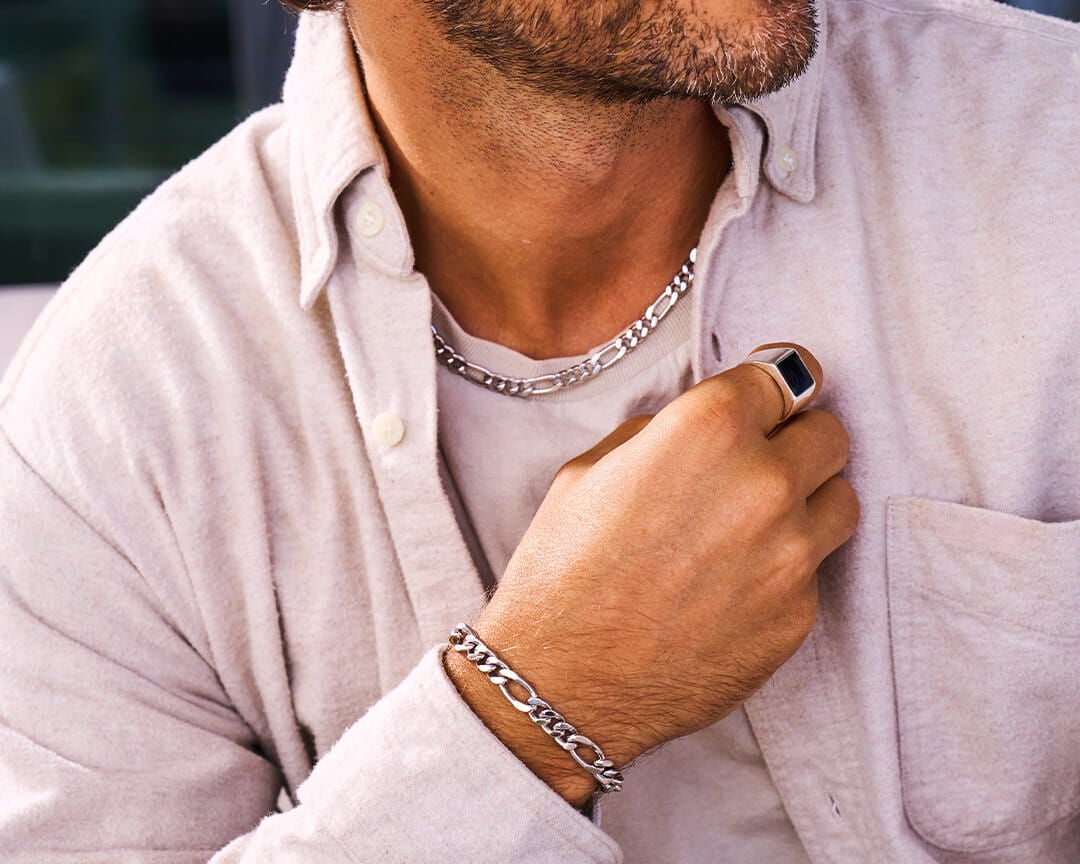 Man wearing a necklace, bracelet, and ring from James Avery Artisan Jewelry